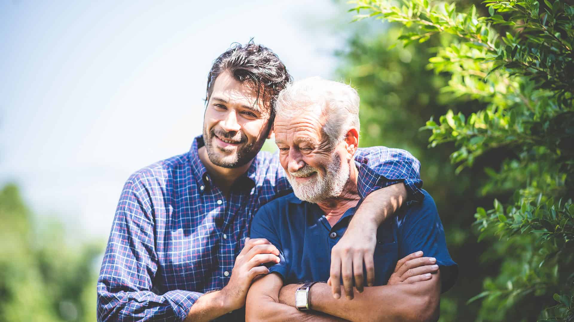 Son and father standing together and talking about Shady Maple while they enjoy Father's day